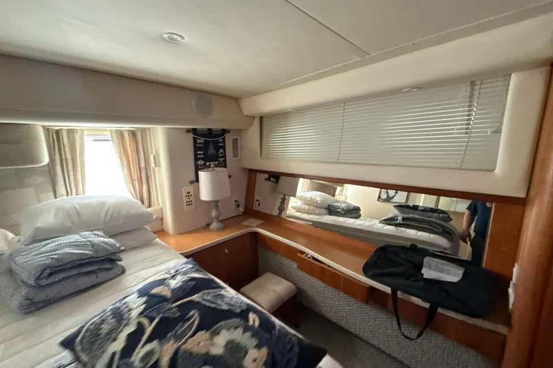 Slide: The Image of Cozy bedroom interior of 1999 Silverton 422 Motor Yacht with bedding and decor. - 38