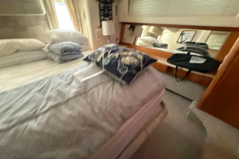 Slide: The Image of Interior cabin of 1999 Silverton 422 Motor Yacht with bed and nautical decor. - 39