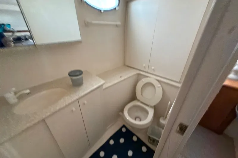 Slide: The Image of Bathroom interior of 1999 Silverton 422 Motor Yacht with sink and toilet. - 42