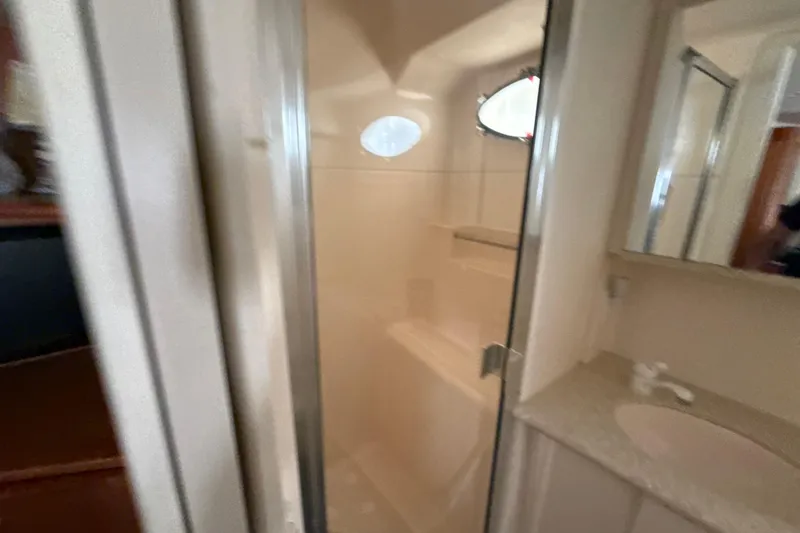 Slide: The Image of Bathroom interior of 1999 Silverton 422 Motor Yacht with shower and sink. - 43