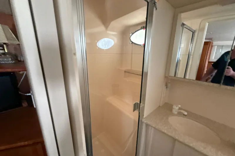 Slide: The Image of Bathroom interior of 1999 Silverton 422 Motor Yacht with shower and sink. - 44