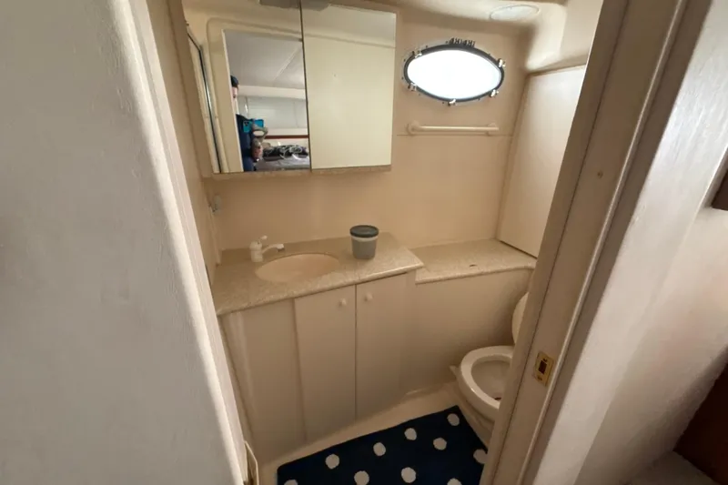 Slide: The Image of Bathroom interior of 1999 Silverton 422 Motor Yacht with mirror and porthole window. - 45