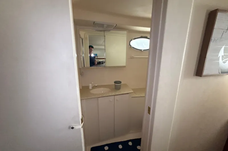 Slide: The Image of Bathroom interior of 1999 Silverton 422 Motor Yacht with mirror and sink. - 46