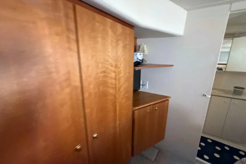 Slide: The Image of Interior of 1999 Silverton 422 Motor Yacht with wooden cabinets and small TV. - 47
