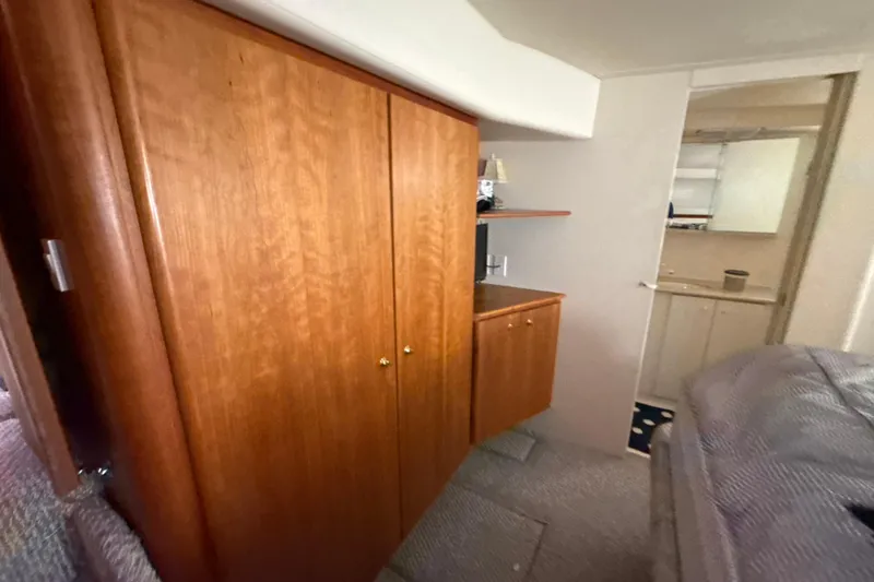 Slide: The Image of Interior of 1999 Silverton 422 Motor Yacht with wooden cabinetry and cozy furnishings. - 48