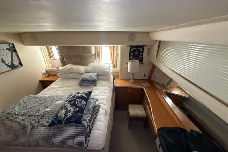 Slide: The Image of Luxurious bedroom interior of a 1999 Silverton 422 Motor Yacht with cozy bedding and elegant decor. - 50
