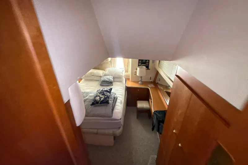 Slide: The Image of Interior cabin of 1999 Silverton 422 Motor Yacht with bed and desk. - 51