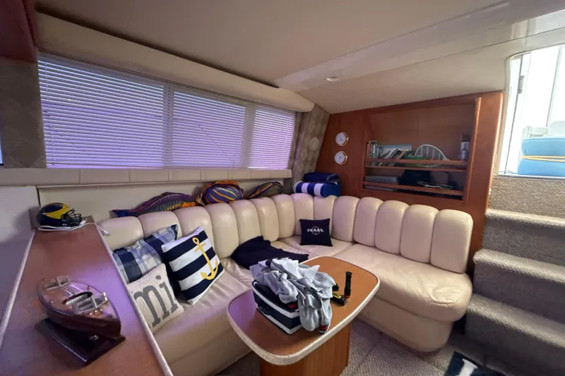 Slide: The Image of Interior of 1999 Silverton 422 Motor Yacht with cozy seating and nautical decor. - 54