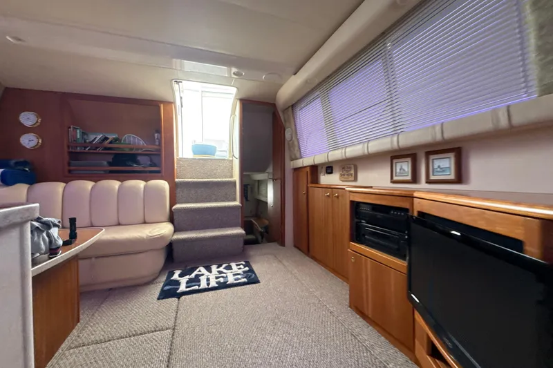 Slide: The Image of Interior of 1999 Silverton 422 Motor Yacht with cozy seating and nautical decor. - 55