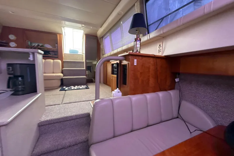 Slide: The Image of Interior of 1999 Silverton 422 Motor Yacht with cozy seating and modern amenities. - 57
