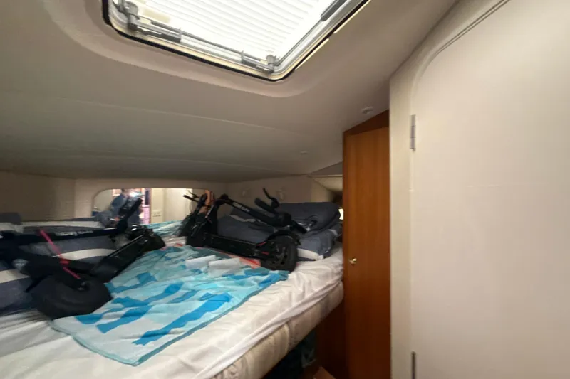Slide: The Image of Interior cabin of 1999 Silverton 422 Motor Yacht with scooters on bed. - 58