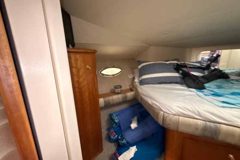 Slide: The Image of Interior cabin of 1999 Silverton 422 Motor Yacht with bed and storage. - 59