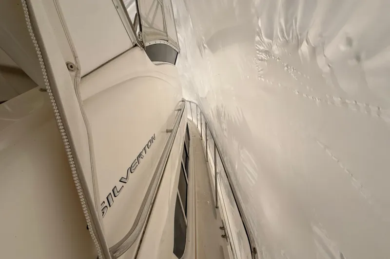 Slide: The Image of 1999 Silverton 422 Motor Yacht covered in protective wrap, side view. - 6