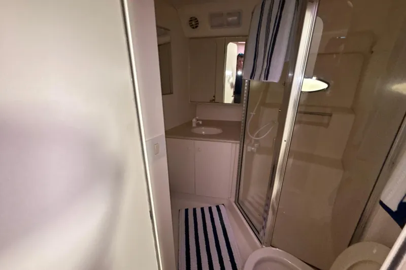 Slide: The Image of Bathroom interior of 1999 Silverton 422 Motor Yacht with shower and sink. - 63