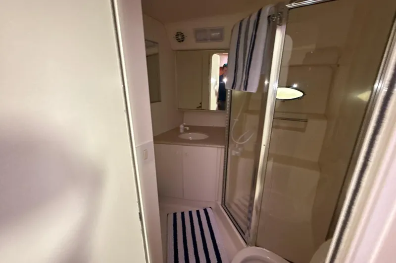 Slide: The Image of Bathroom interior of 1999 Silverton 422 Motor Yacht with shower and sink. - 64