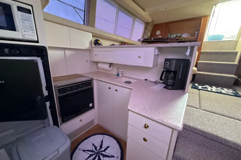 Slide: The Image of Interior of 1999 Silverton 422 Motor Yacht kitchen with appliances and stairs. - 66