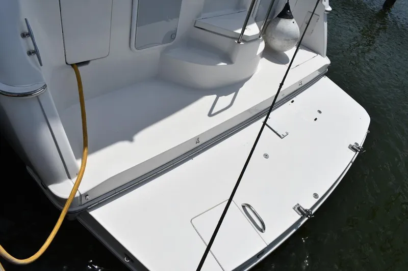 Slide: The Image of 1999 Silverton 422 Motor Yacht stern view with swim platform and dock lines. - 8