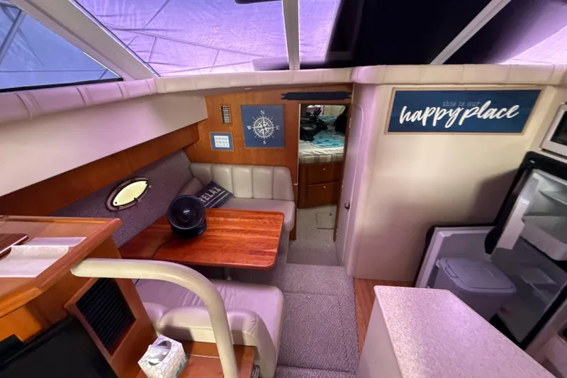 Slide: The Image of Interior of 1999 Silverton 422 Motor Yacht with cozy seating and nautical decor. - 71
