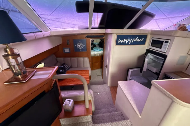 Slide: The Image of Interior of a 1999 Silverton 422 Motor Yacht with cozy seating and kitchen area. - 72