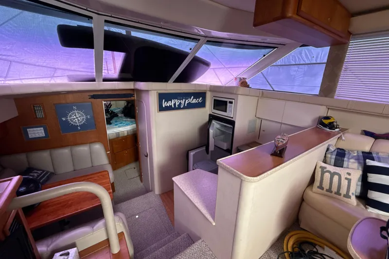 Slide: The Image of Interior of a 1999 Silverton 422 Motor Yacht with cozy seating and nautical decor. - 73