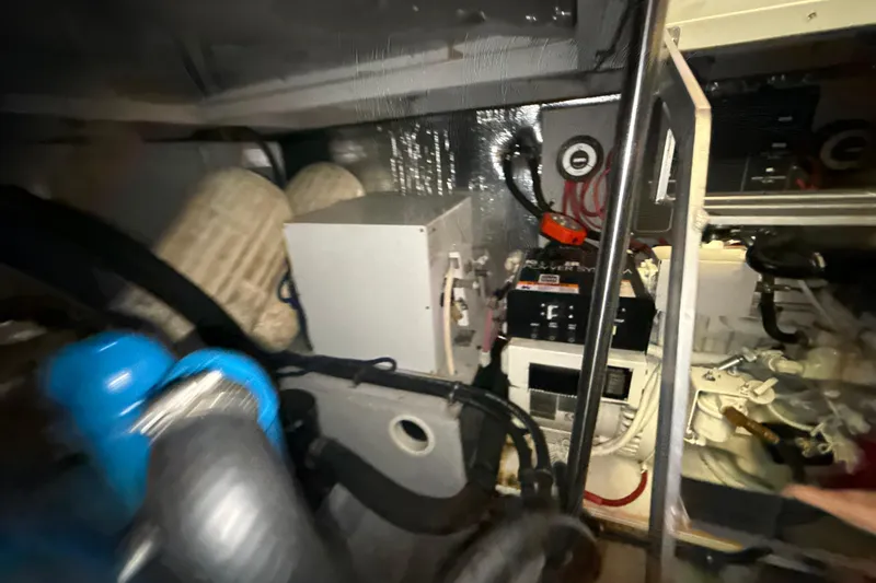 Slide: The Image of Engine room of a 1999 Silverton 422 Motor Yacht with visible machinery and components. - 76