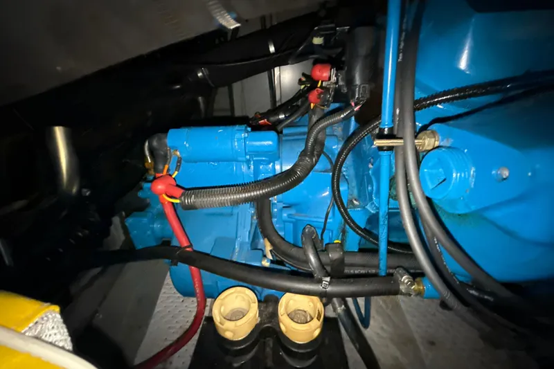 Slide: The Image of Engine compartment of a 1999 Silverton 422 Motor Yacht, featuring blue engine components. - 79