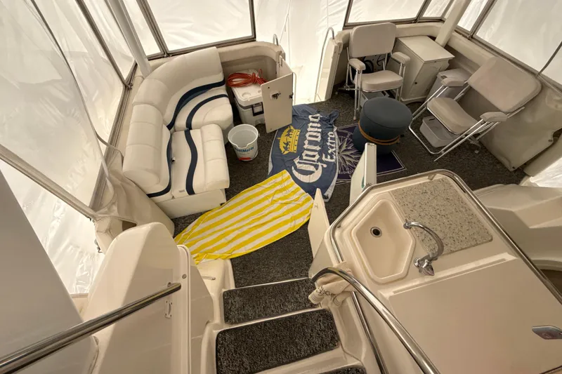 Slide: The Image of 1999 Silverton 422 Motor Yacht interior with seating, kitchenette, and nautical decor. - 8
