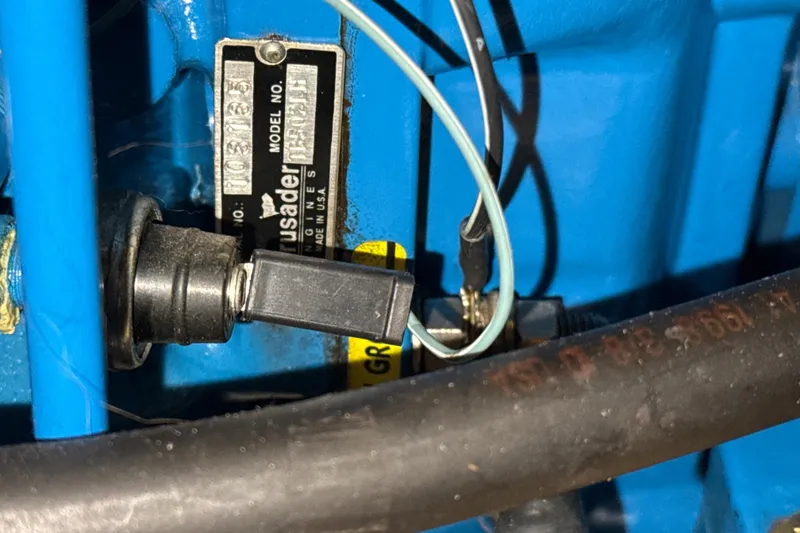 Slide: The Image of Close-up of a 1999 Silverton 422 Motor Yacht engine component with wiring and label. - 83