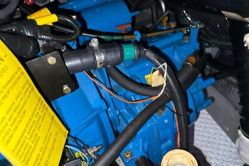 Slide: The Image of Engine compartment of a 1999 Silverton 422 Motor Yacht with visible hoses and components. - 86