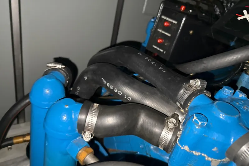 Slide: The Image of Engine components of a 1999 Silverton 422 Motor Yacht, featuring hoses and clamps. - 88