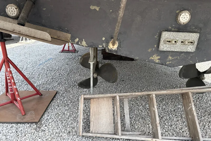 Slide: The Image of 1999 Silverton 422 Motor Yacht under maintenance, showing propellers and hull details. - 92