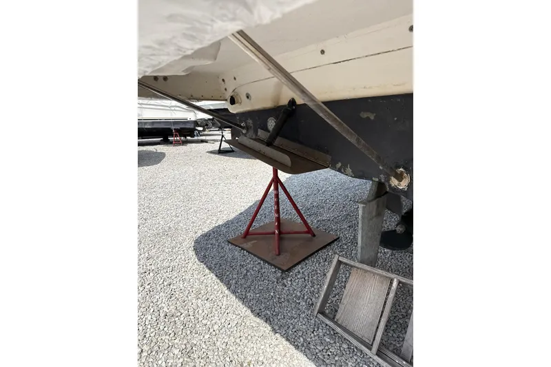 Slide: The Image of 1999 Silverton 422 Motor Yacht on stands, showing hull and propeller area. - 98