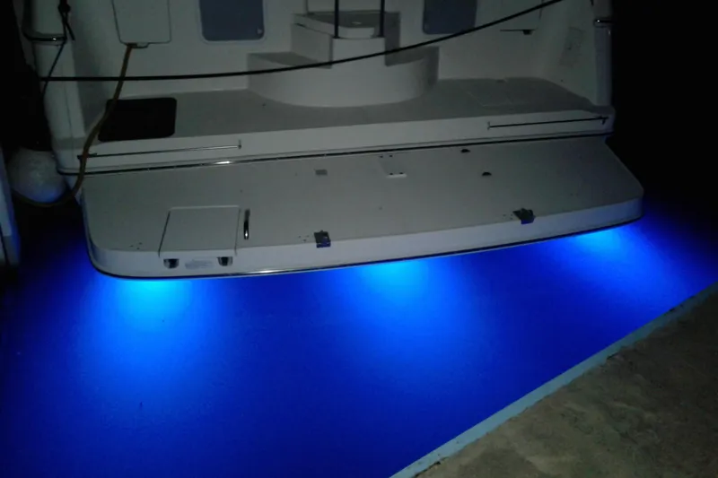 Slide: The Image of 1999 Silverton 422 Motor Yacht with blue underwater lights at night. - 99