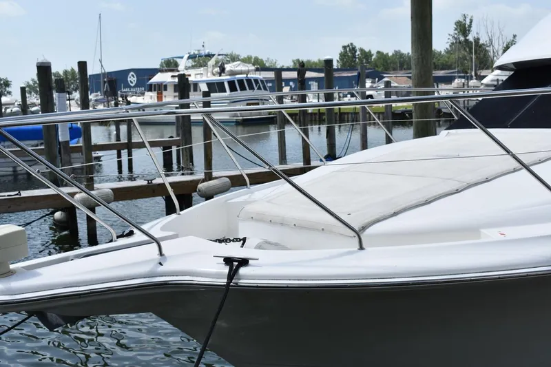 Slide: The Image of 1999 Silverton 422 Motor Yacht docked at marina, showcasing sleek design and spacious deck. - 4