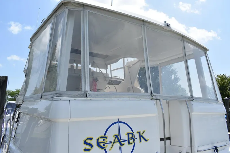 Slide: The Image of 1999 Silverton 422 Motor Yacht with enclosed deck, featuring "SEABK" logo. - 11