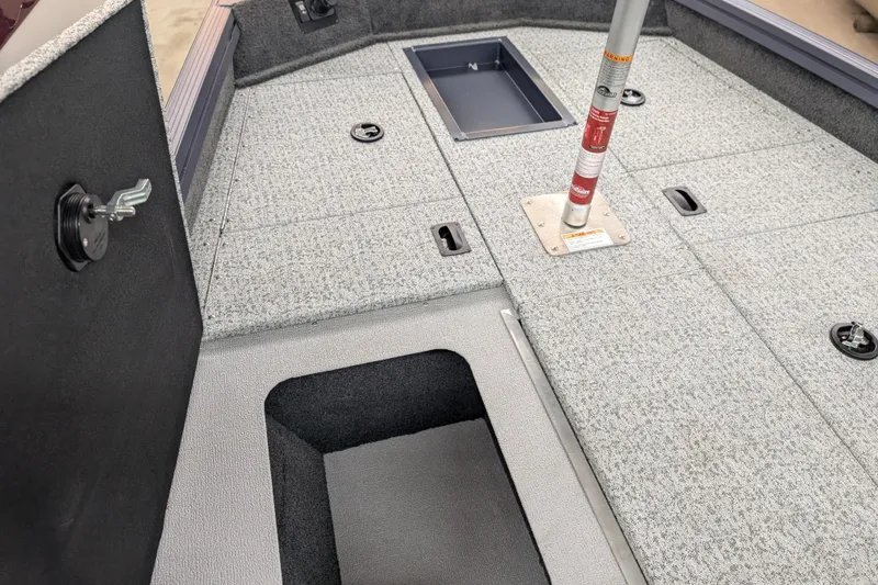 Slide: The Image of 2026 Smoker Craft Viper XR 165 boat interior with storage compartments and seat base. - 14