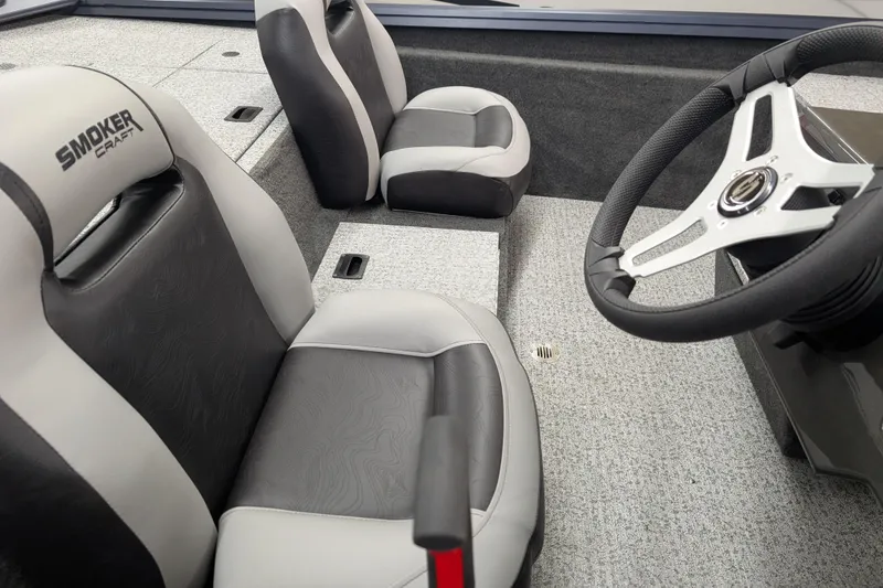 Slide: The Image of 2026 Smoker Craft Viper XR 165 boat interior with steering wheel and seating. - 2