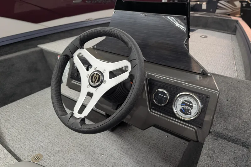 Slide: The Image of 2026 Smoker Craft Viper XR 165 boat interior with steering wheel and dashboard controls. - 3