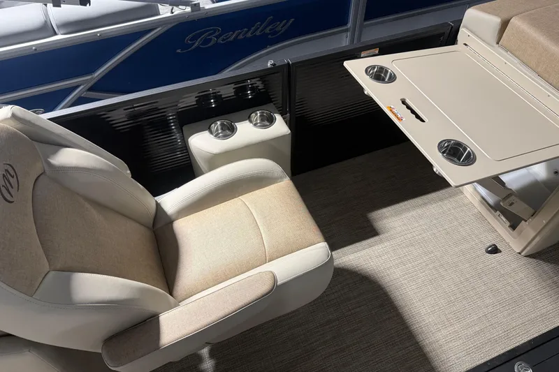 Slide: The Image of Luxurious seating and table setup on 2026 Manitou 23 AURORA RF VPII 575 boat. - 16