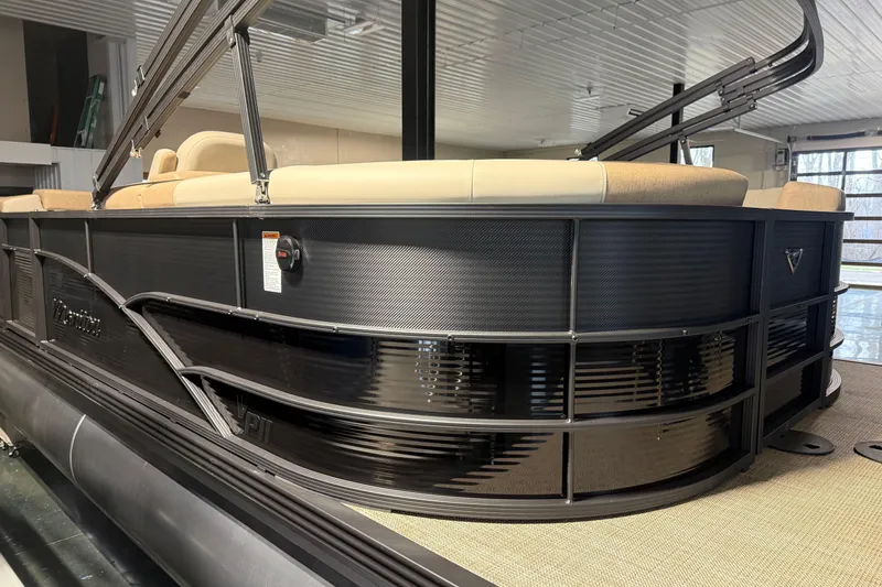 Slide: The Image of 2026 Manitou 23 AURORA RF VPII 575 pontoon boat in showroom, side view. - 2