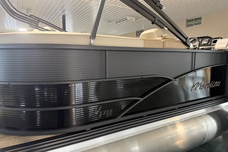Slide: The Image of 2026 Manitou 23 AURORA RF VPII 575 pontoon boat with sleek black exterior design. - 4