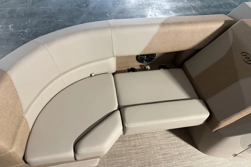 Slide: The Image of Luxurious seating on 2026 Manitou 23 AURORA RF VPII 575 boat, featuring beige upholstery. - 5