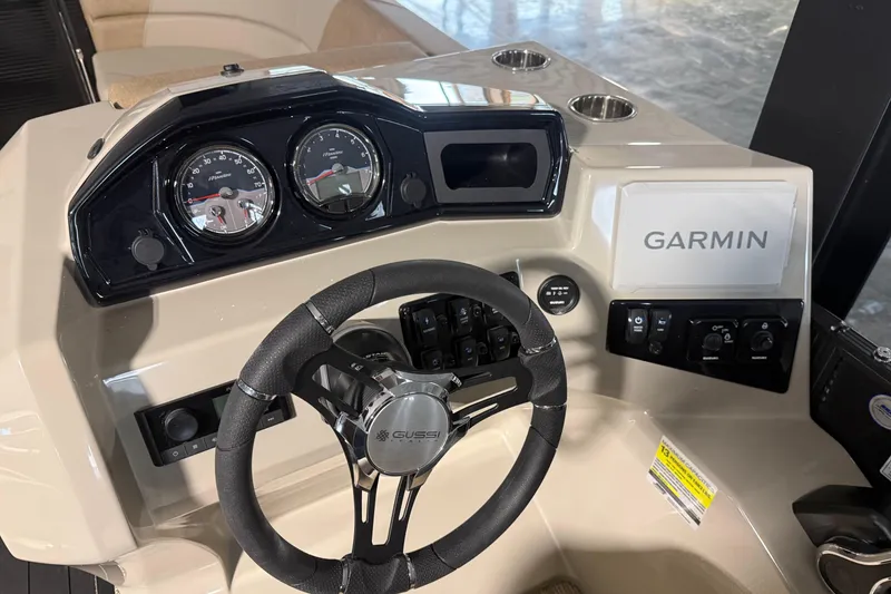 Slide: The Image of 2026 Manitou 23 AURORA RF VPII 575 dashboard with Garmin navigation and Gussi steering wheel. - 8