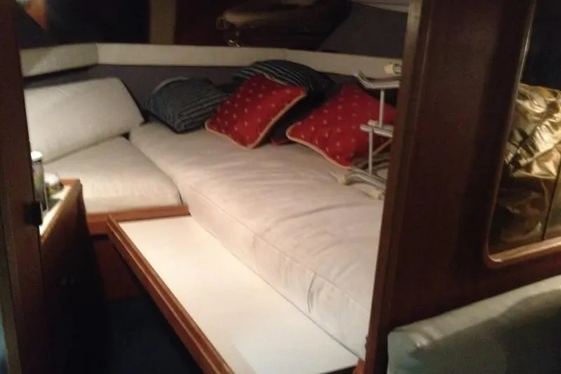Slide: The Image of Cozy cabin interior of 1989 Tiara Yachts 3100 Open with cushions and pillows. - 5