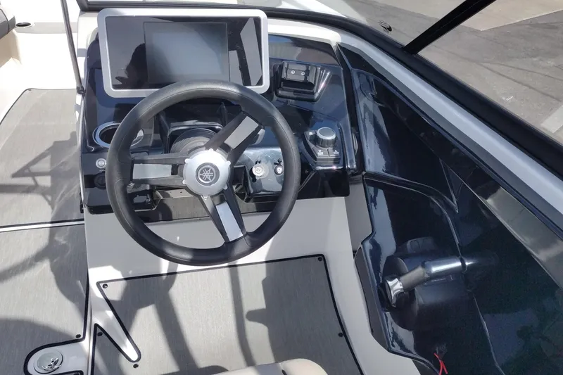 Slide: The Image of 2023 Yamaha AR250 boat dashboard with steering wheel and control panel. - 11