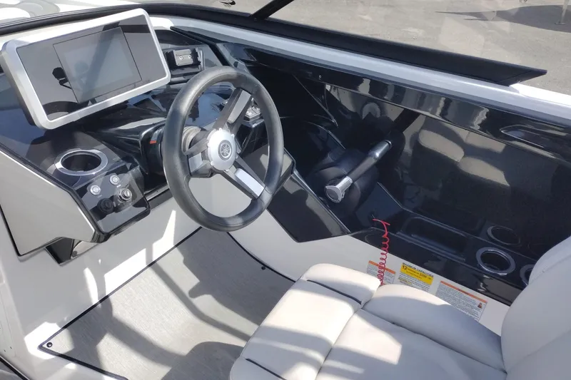 Slide: The Image of 2023 Yamaha AR250 boat cockpit with steering wheel and modern dashboard controls. - 12