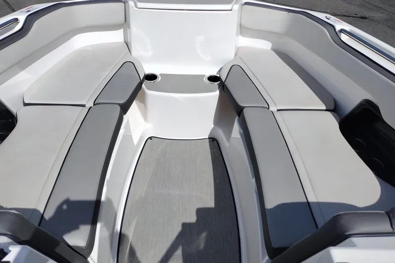 Slide: The Image of 2023 Yamaha AR250 boat interior with cushioned seating and cup holders. - 13