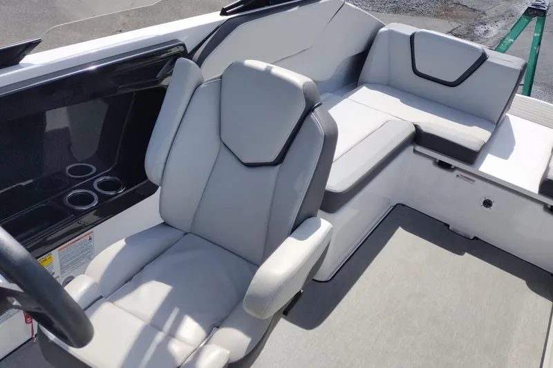 Slide: The Image of 2023 Yamaha AR250 boat interior with sleek gray seating and cup holders. - 16