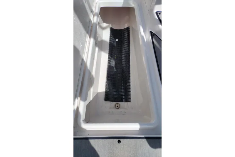 Slide: The Image of 2023 Yamaha AR250 boat storage compartment with black mat. - 19
