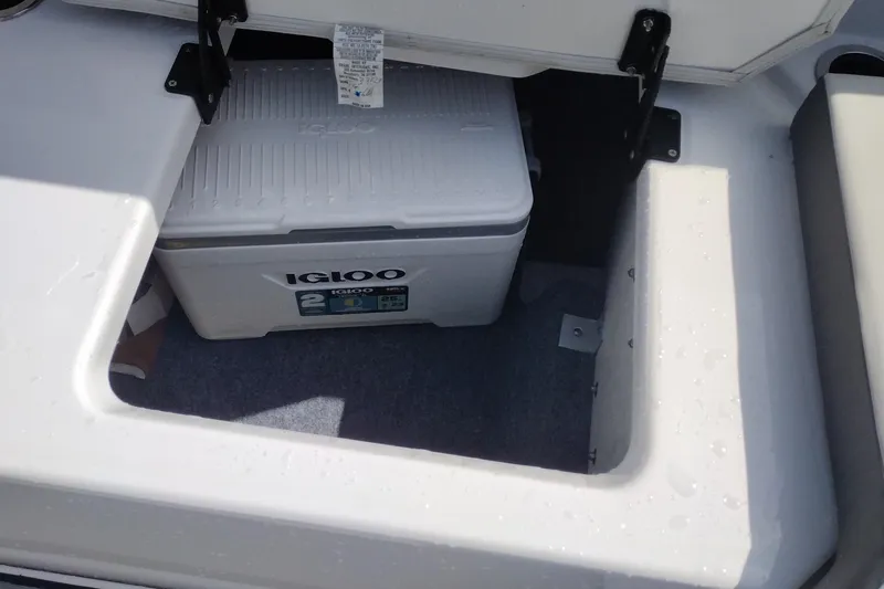 Slide: The Image of Storage compartment in 2023 Yamaha AR250 boat with Igloo cooler inside. - 25